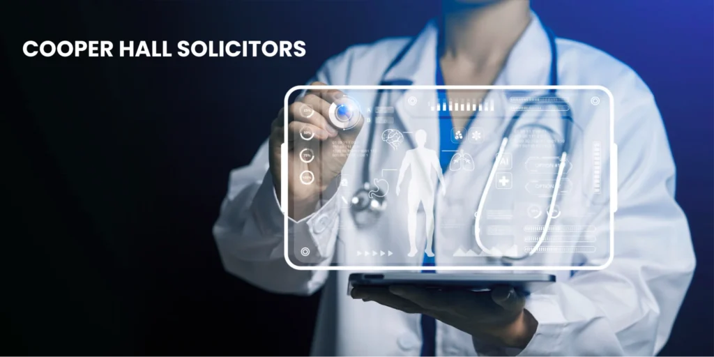Doctor using a digital healthcare interface while reviewing patient data, representing how to claim for medical negligence with expert legal support from Cooper Hall Solicitors