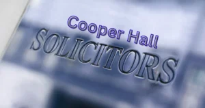 Cooper Hall Solicitors' branding displayed on a professional office sign, highlighting legal support for clients seeking to check CICA claim progress, resolve claim delays, and pursue criminal injury compensation claims