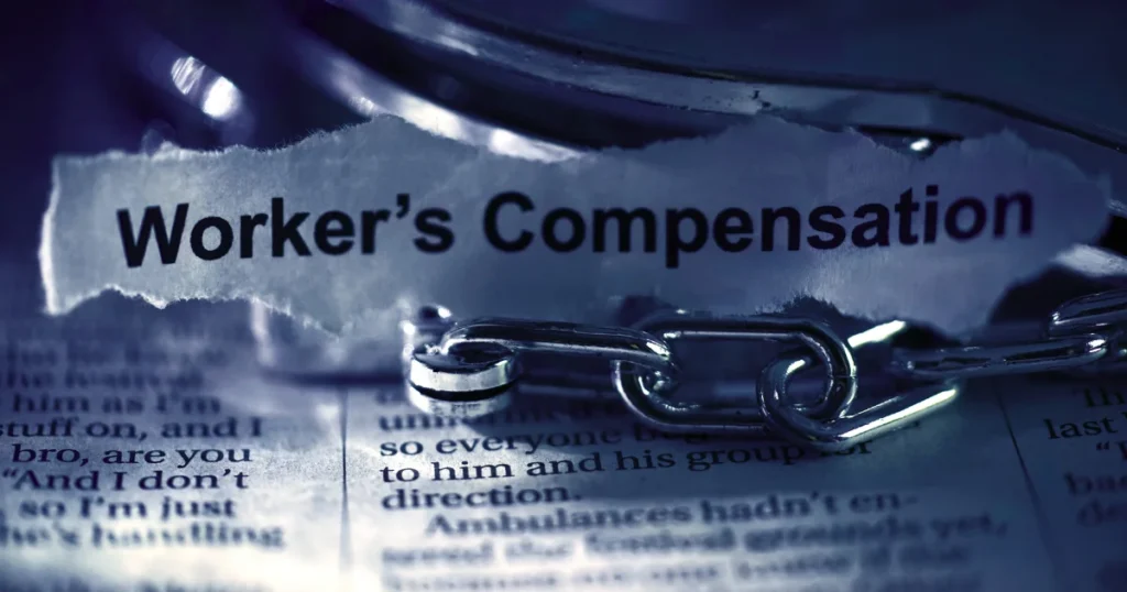 Close-up of a document displaying the words Worker's Compensation with a metal chain in the foreground, symbolizing legal claims and financial recovery, representing Criminal Injury Compensation and victim compensation after a violent crime. 
