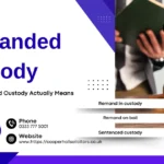 Cooper Hall Solicitors banner explaining remanded custody under UK law with a judge's gavel and legal professional, highlighting remand in custody, bail options, sentenced custody, and criminal defence legal advice.
