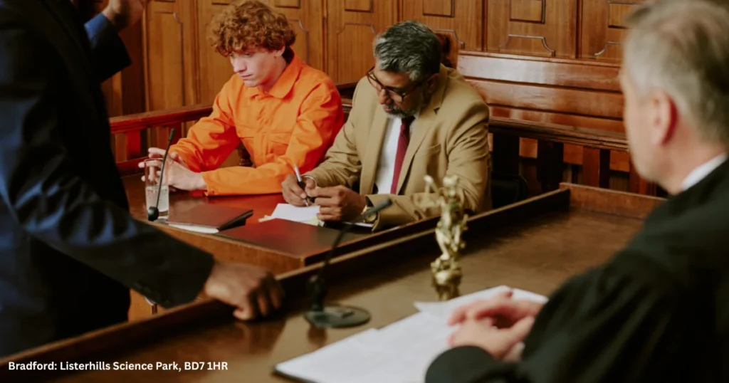 Pictured, the defendant sits with a solicitor in court as proceedings take place in front of the judge - demonstrating the case of an individual remanded in custody pending sentence, after a court hearing.
