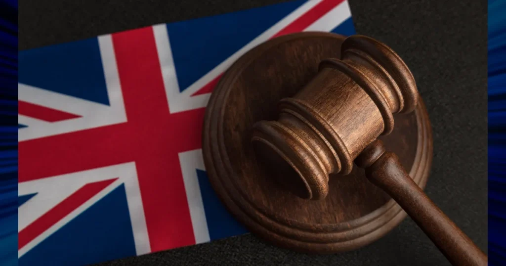 Wooden judge gavel on UK flag. Concept of conditional bail decisions in UK criminal law, court proceedings, bail conditions and legal rights in criminal case.